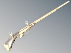A decorative brass and wooden musket