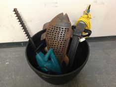 A garden pot containing metal fish ornament,