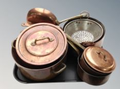A group of copper and brass cooking pans,
