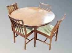 A reproduction mahogany extending dining table and four chairs