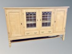A Danish blond oak sideboard with leaded glass doors,