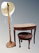 A reproduction mahogany two drawer console table together with a further circular low table and a