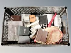 A crate containing hip flask, torch,