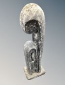 A contemporary abstract garden statue depicting a mother and child,