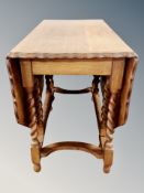 An oak pie crust drop leaf gate leg table