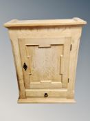 A blond oak wall cabinet,