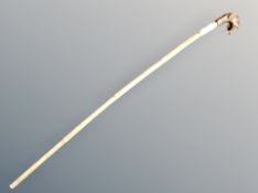 A walking stick with dog's head pommel