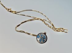 9ct gold and enamelled lapel badge on an 18