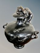 A heavy bronze embossed twin handled urn