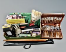 A canteen of cutlery and a box of board games,