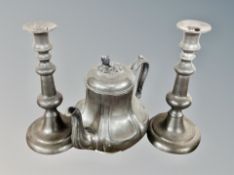 A 19th century pewter teapot together with further pair of antique pewter candlesticks