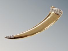 A silver diamond claw pendant