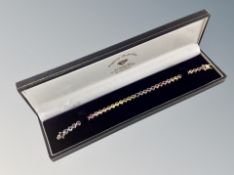 A silver multi coloured tennis bracelet