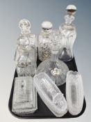 Five assorted cut glass crystal decanters, butter dish,