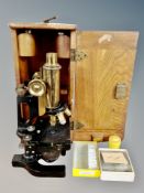A Bausch and Co New York microscope with lenses and slides in fitted box