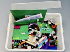 A plastic caddy containing Lego friends