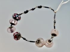 Seven silver Rhona Sutton bead charms