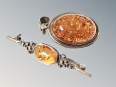 A silver amber brooch pendant