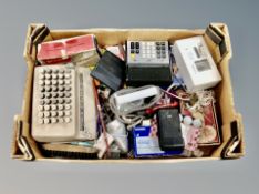 A box of shoe stretchers, adding machine, calculator, radio,