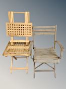 A folding wooden garden armchair together with two further folding teak lattice tables
