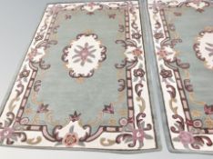 An Indian rug on green ground,