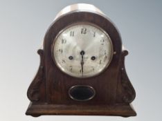 An early 20th century Junghans oak cased mantel clock with silvered dial