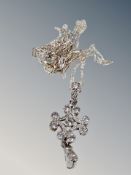 A silver cubic zirconia pendant on fancy chain