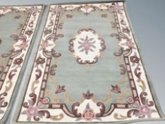 An Indian rug on green ground,