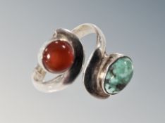 A silver cross over ring