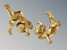 A pair of resin cherub ornaments