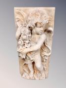 A concrete cherub wall plaque