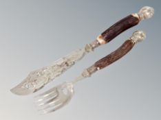 A serving knife and fork with horn handles