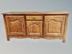 An oak French style farmhouse triple door sideboard
