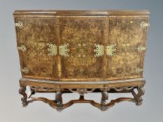 A burr walnut shaped triple door cabinet with gilt metal mounts