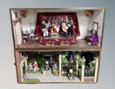 Two dioramas in cases depicting a dog band and monks in a garden scene,