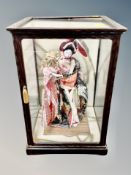 A Geisha doll in display case,