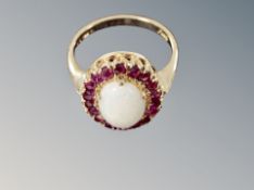 A ruby and opal cluster ring, size L, cluster dimensions 12.8 mm x 14.65 mm.