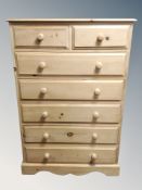 A stripped pine seven drawer chest