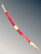 An Indian brass handled sword in scabbard