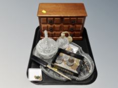 A four drawer wooden jewellery chest together with a part glass dressing table set, perfume bottle,