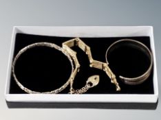 A gate bracelet and two bangles