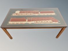 A Scandinavian rectangular coffee table with top depicting two locomotives,