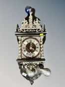 A Continental silvered wall clock with pear drop weights