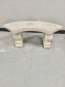 A concrete crescent shaped garden bench height 41 cm