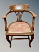 A stained oak smoker's armchair