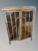 An Art Deco walnut serpentine fronted cabinet,