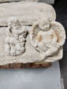 Two concrete cherub ornaments