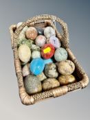 A wicker basket containing a collection of onyx eggs