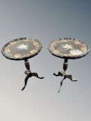 A pair of ebonised and gilt shaped tripod occasional tables