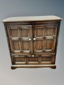 An Ercol stained elm double door cabinet,
